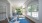 a lounge area with rocking chairs and windows