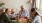 a group of people sitting around a table