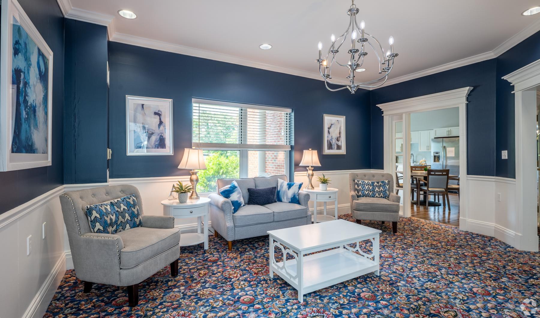 State-of-the-art amenities a clubroom with a couch and chairs